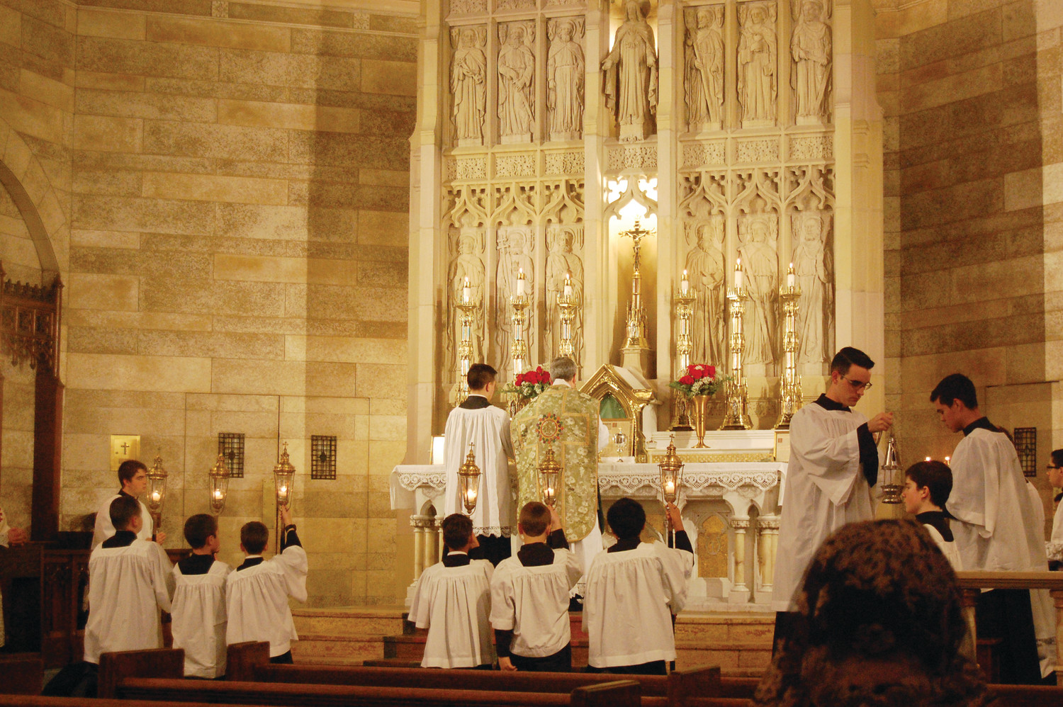 Father John Berg, center, celebrates the Traditional Latin Mass at St. Mary’s Church on Broadway in Providence. The Priestly Fraternity of St. Peter recently assumed leadership of the parish.